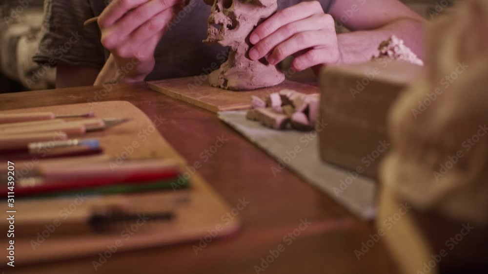 Young artist sculpting bust of monster with Plasticine (non-drying clay) Young artist sculpting bust of monster with Plasticine (non-drying clay)