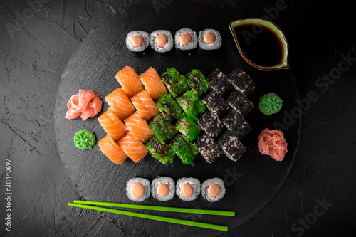 Sushi set of Philadelphia, California with fresh ingredients on black background. Sushi menu. Japanese food. 