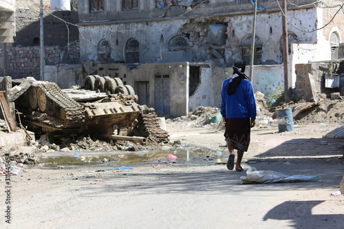 A Yemeni walking amid the great devastation caused by the war  in Taiz, Yemen © akram.alrasny