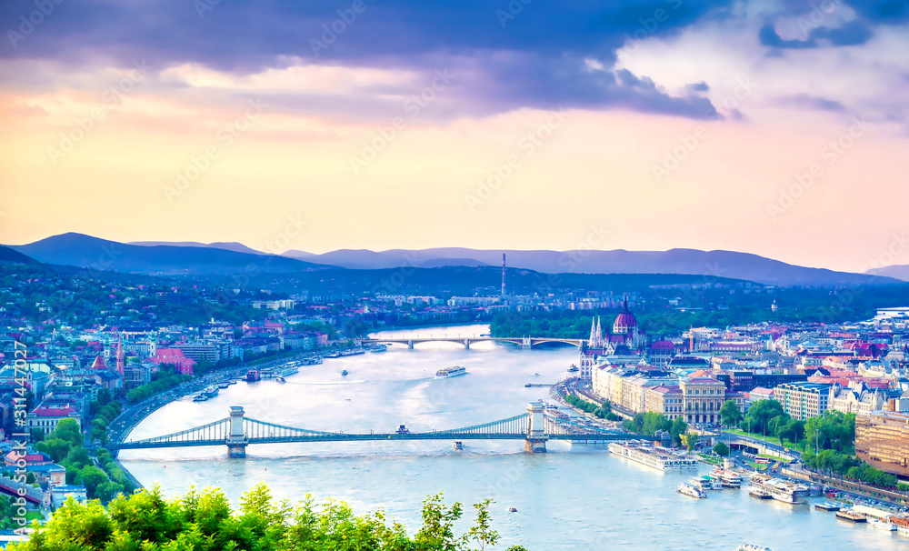 A view along the Danube River of Budapest, Hungary from Gellert Hill at sunset.