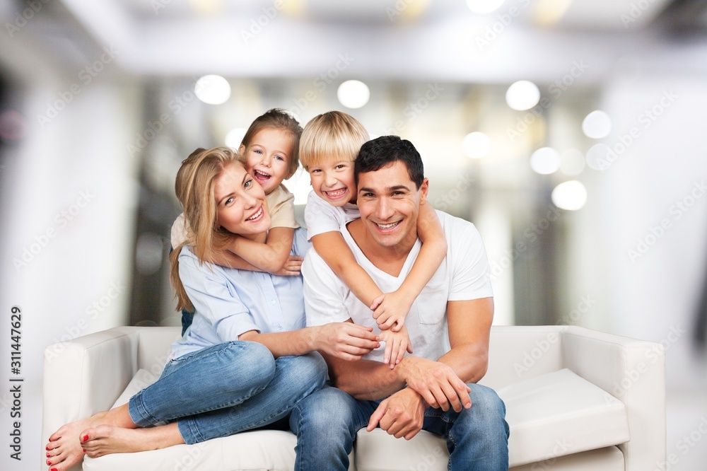 Beautiful smiling Lovely family siting on sofa Beautiful smiling Lovely family siting on sofa