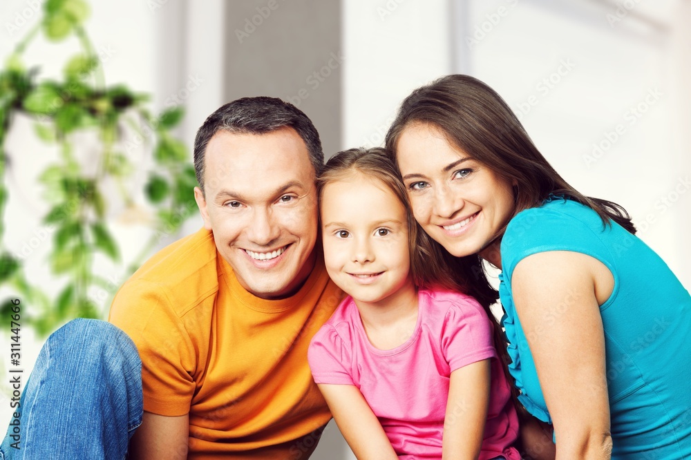 Beautiful smiling Lovely family siting on sofa Beautiful smiling Lovely family siting on sofa
