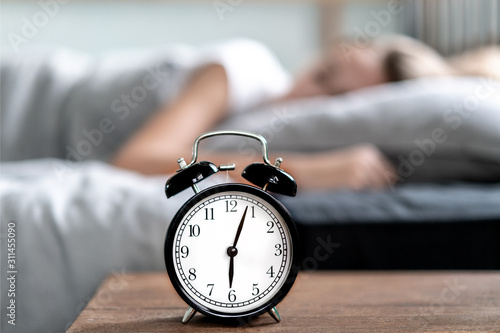 Woman with insomnia lying in bed with open eyes. Early morning hours. Insomnia and sleep problems. Relax and sleep concept. Feels sleepy and tired. Early to get up. Relax and sleep concept.