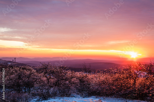 Vivid stunning sunset at High Point State Park, top of NJ, first day of winter covered in ice and snow