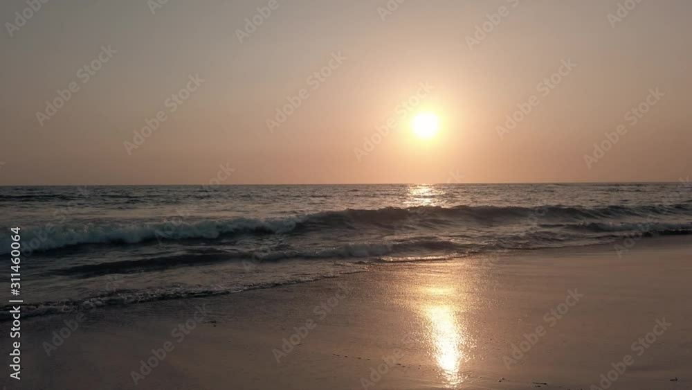 A beautiful sunset at Canggu Beach in Bali during golden hour, wave crashing on shore. A beautiful sunset at Canggu Beach in Bali during golden hour, wave crashing on shore.