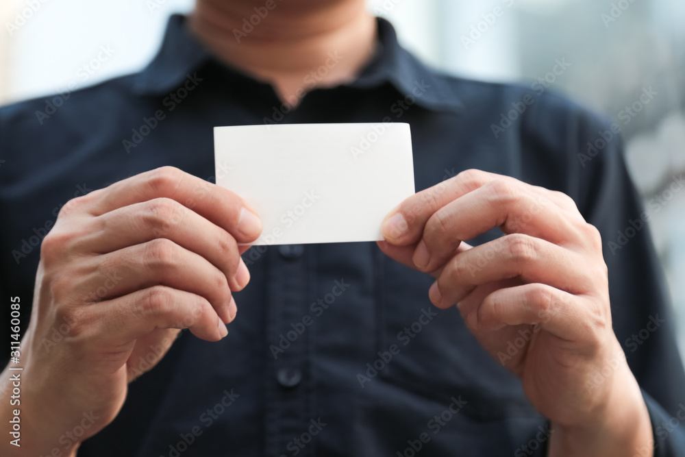 Obraz premium Confident male business executive with empty white business card