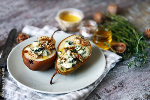 Baked pears with thyme and cheese. Keto diet. Healthly food. Selective focus. Macro.