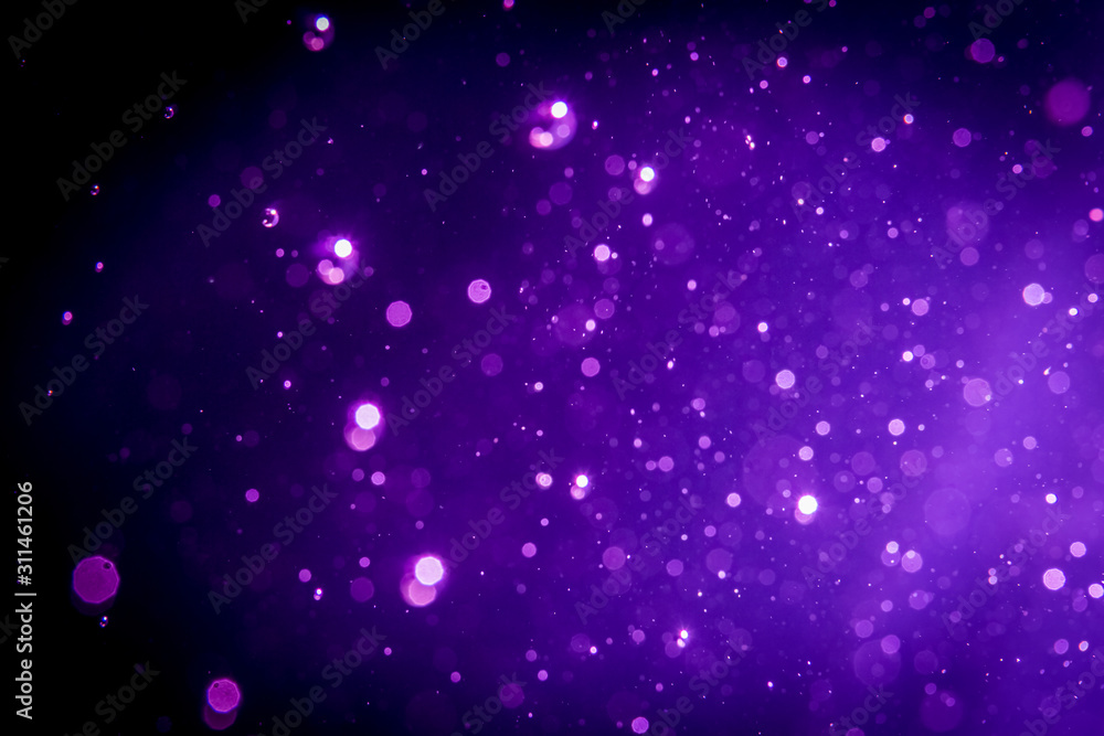 Fototapeta premium Abstract purple , violet bokeh on black