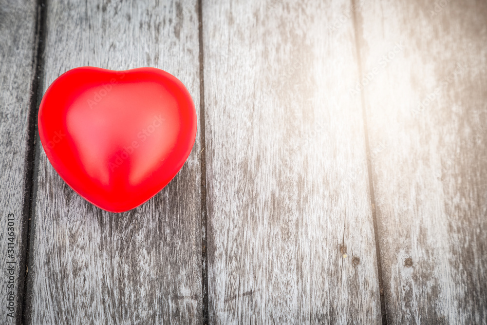 Red heart on wooden table