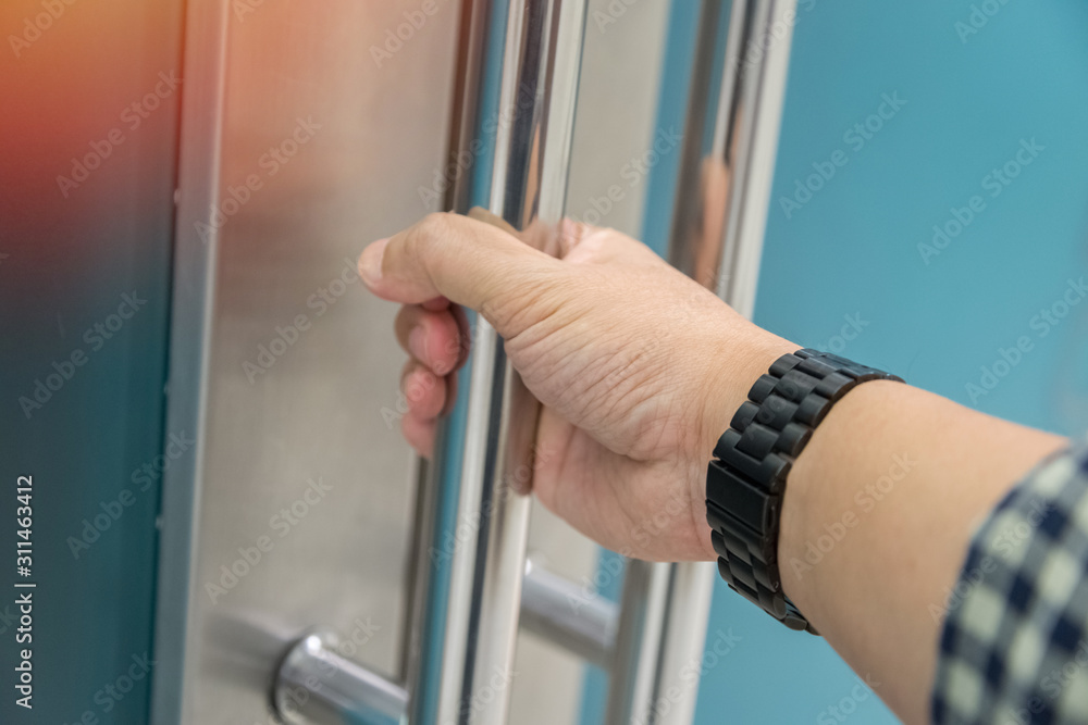Hand opening metal modern office door with reflection