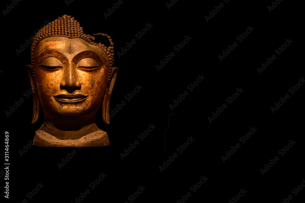 Buddha head image on black background.