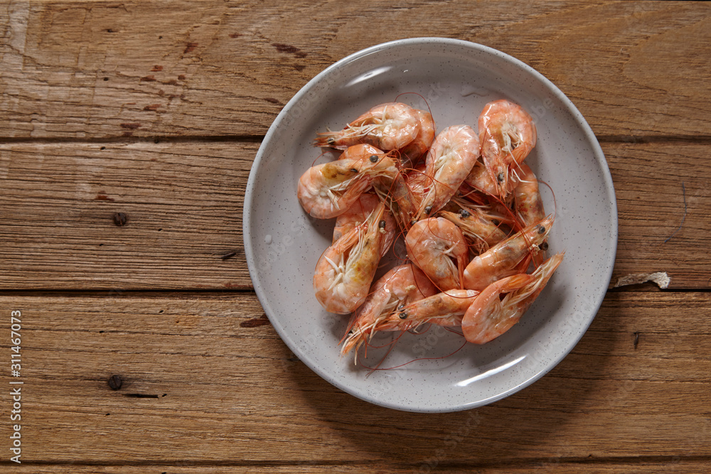 Boiled fresh shrimp on a plate isolated on white background Boiled fresh shrimp on a plate isolated on white background