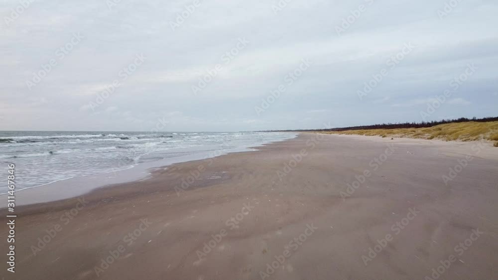 Aerial drone flyover at Perkone sandy beach Baltic sea coastline after the sunset, no people, autumn, spring, relieving shot Aerial drone flyover at Perkone sandy beach Baltic sea coastline after the sunset, no people, autumn, spring, relieving shot