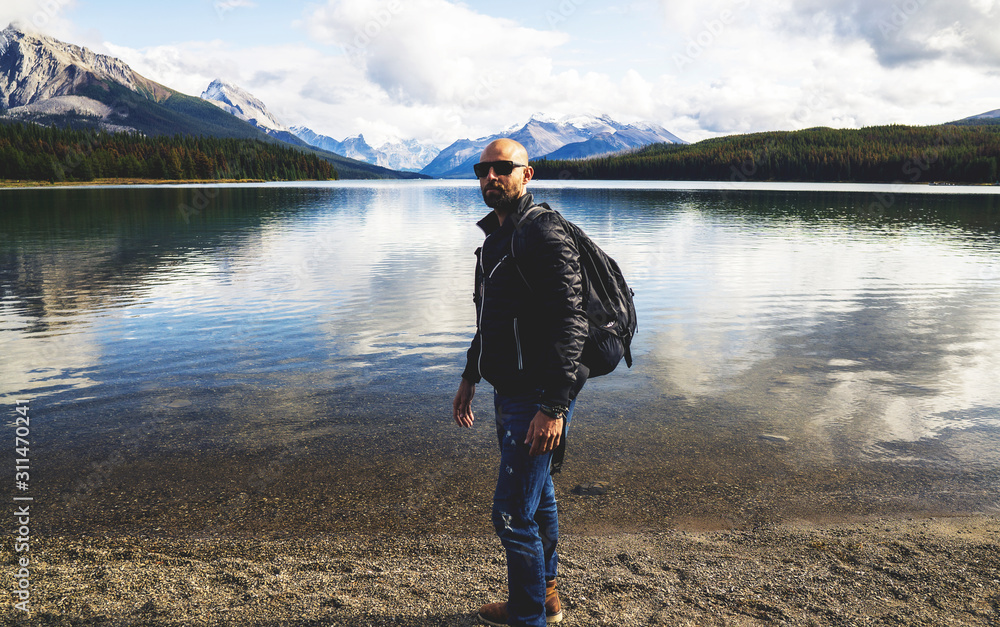 Woodsman Standing On Epic Lake Shore With Backpack Woodsman Standing On Epic Lake Shore With Backpack