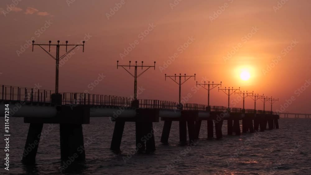 Pan shot of the approach lighting system towers at sunset. Pan shot of the approach lighting system towers at sunset.