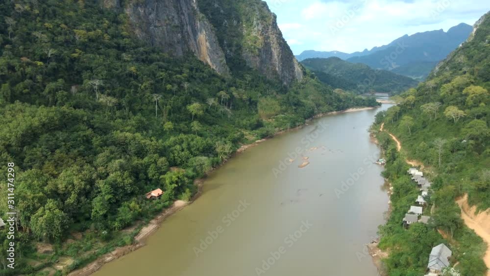 A picturesque of Nong Khiaw and Nam Ou river surrounded bu huge mountains. Laos. Aerial. A picturesque of Nong Khiaw and Nam Ou river surrounded bu huge mountains. Laos. Aerial.
