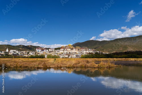 Peaceful landscape background and water reflection of Songzanlin Tibetan Monastery in Shangri-la, Zhongdian, Diqig, China