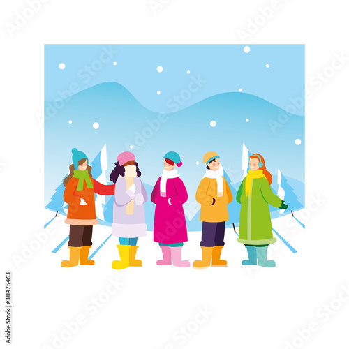 group of people with winter clothes in landscape with snowfall