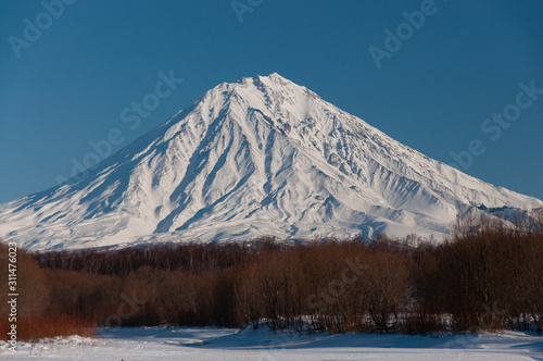 Winter view of Kamchatka volcanoes full of snow.