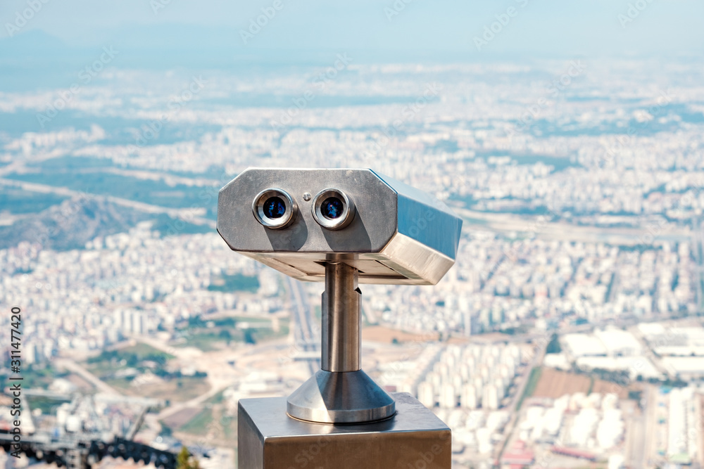 stationary binoculars for long-range observation mounted on a hill