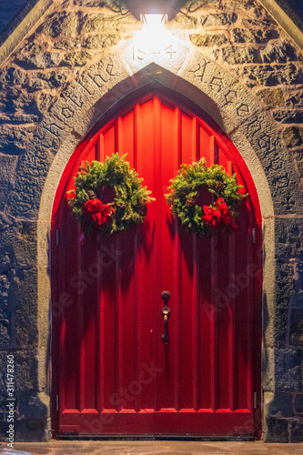 Church Red Doors with Christmas Wreath at Night