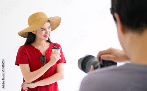 Photographer take a photo working with female model in studio photo