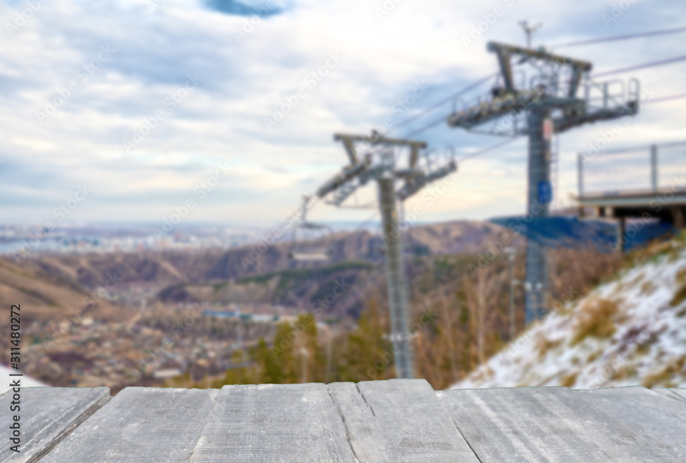 Empty table on blur background of ski lift in the mountains Empty table on blur background of ski lift in the mountains