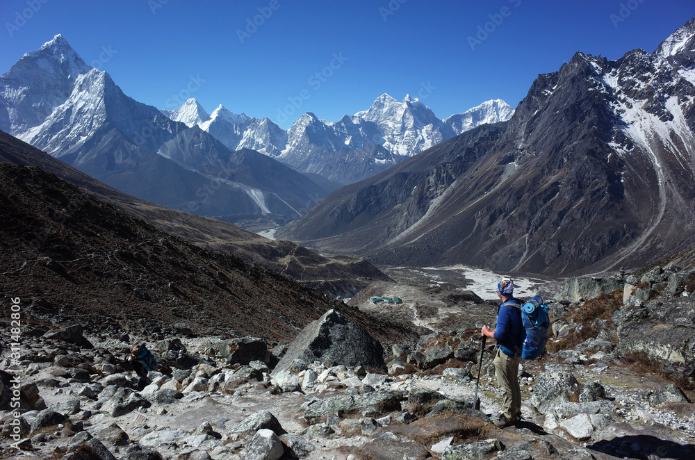 Everest trek, Hiker is enjoying the view of Himalayas with Ama Dablam mountain. Sagarmatha national park, Solukhumbu, Nepal Everest trek, Hiker is enjoying the view of Himalayas with Ama Dablam mountain. Sagarmatha national park, Solukhumbu, Nepal