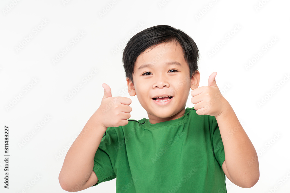 Very happy Asian boy making thumbs up sign with hands laughing happily (Asian ethnicity boy isolated on white background) Very happy Asian boy making thumbs up sign with hands laughing happily (Asian ethnicity boy isolated on white background)