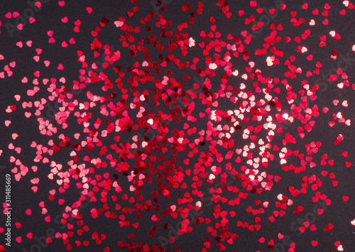 Valentine's day red hearts glitter on black background, holyday background