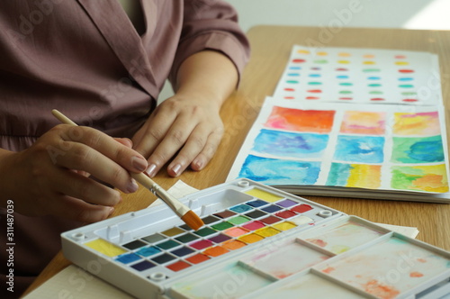 Watercolor paints and brushes workplace artist with artistic tools for mock up.Creative Design Concept.