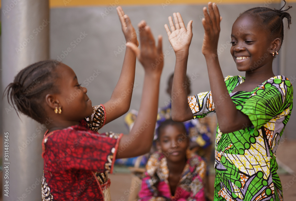 Two Little African Girls Performing A Hand Clapping Game - obrazy, fototapety, plakaty 
