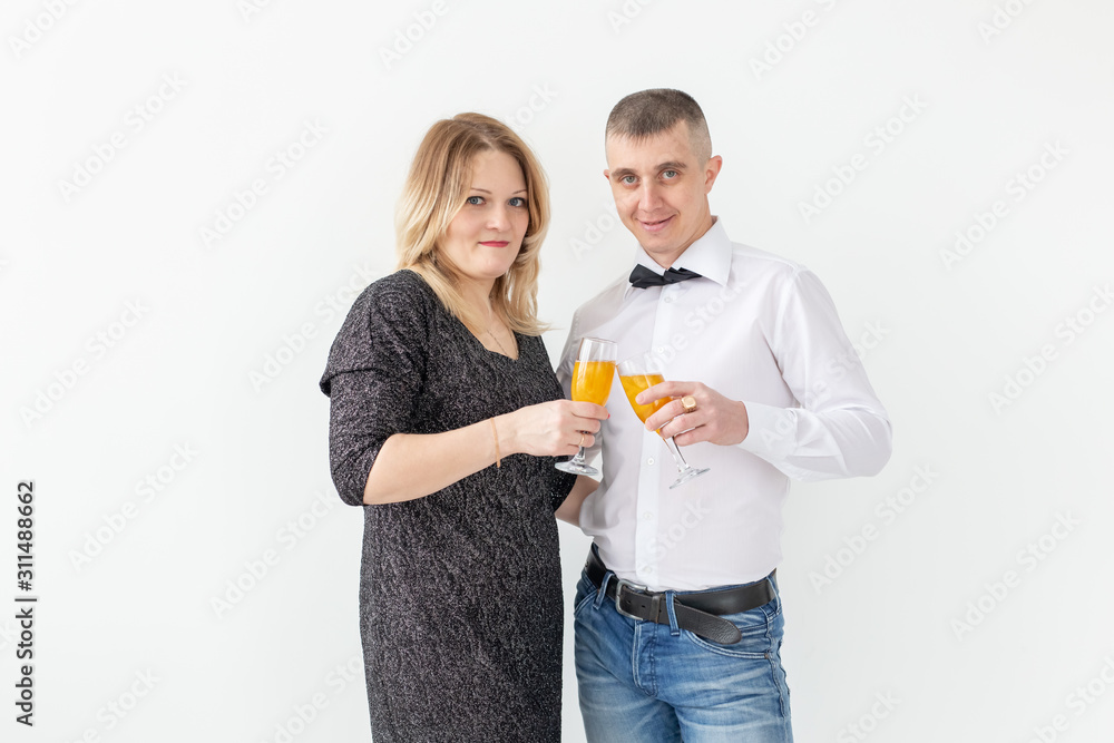 Holidays, christmas, valentine's day and new year concept - Woman and man celebrate and holds wine in a glass over white background