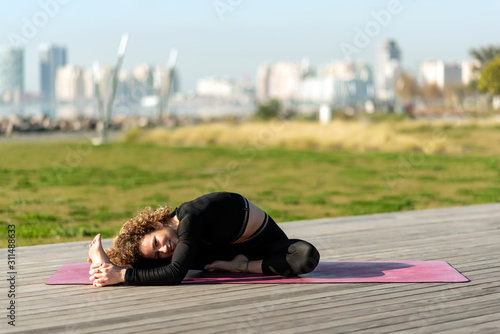 woman doing yoga exercise away from city life