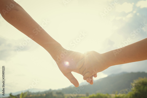 Brother and sister hold hands.Happy in making merit. Mother's love in the hand, on the palm