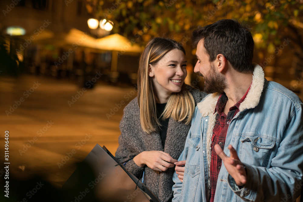 Fototapeta premium Young couple outside with shopping bags