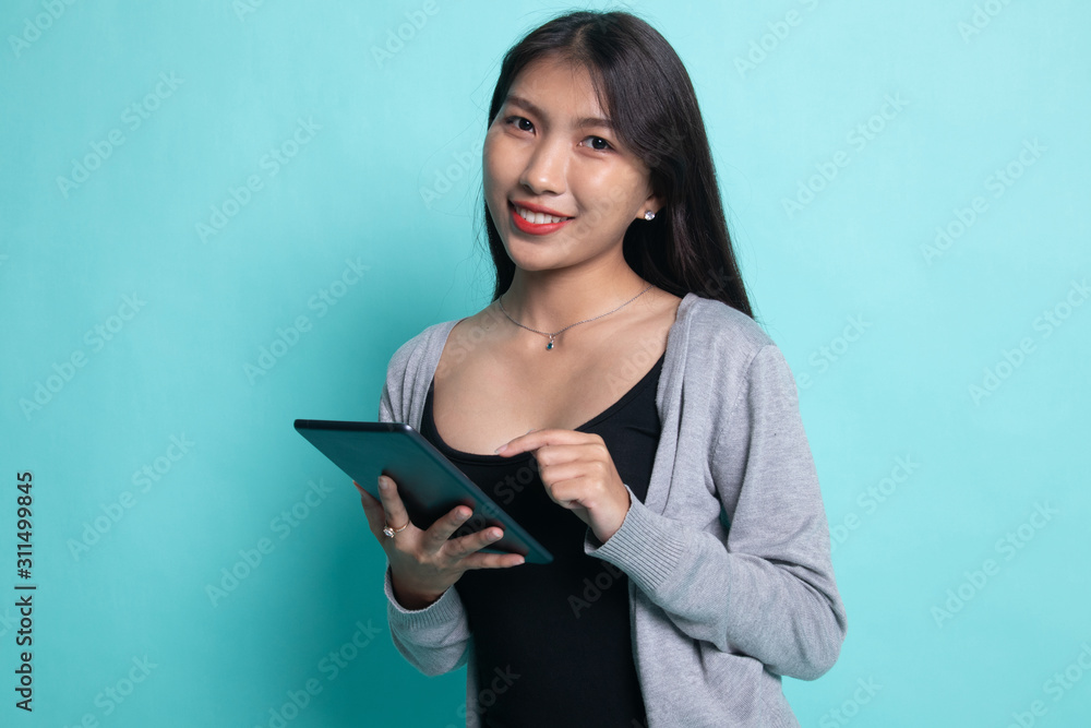 Young Asian woman with a computer tablet. Young Asian woman with a computer tablet.