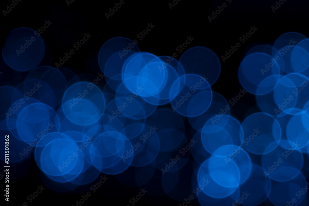 Defocused of blurred blue bokeh circle light from lighting bulb in the night for abstract background texture patterns Defocused of blurred blue bokeh circle light from lighting bulb in the night for abstract background texture patterns