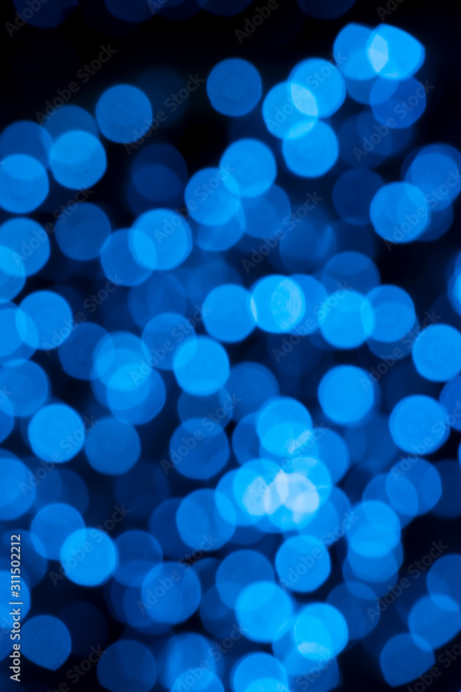 Defocused of blurred blue bokeh circle light from lighting bulb in the night for abstract background texture patterns Defocused of blurred blue bokeh circle light from lighting bulb in the night for abstract background texture patterns
