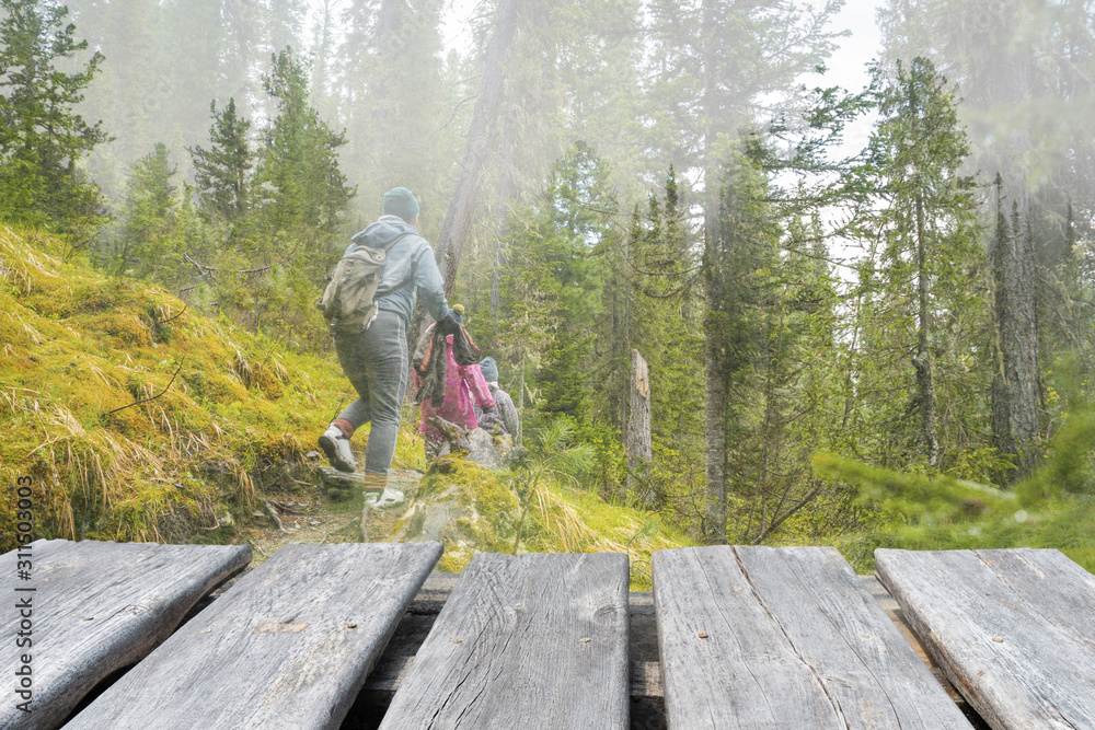 empty wooden table on the blur background of hiking family