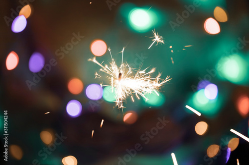 Burning sparkler in hands c...