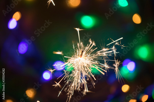 Burning sparkler in hands c...