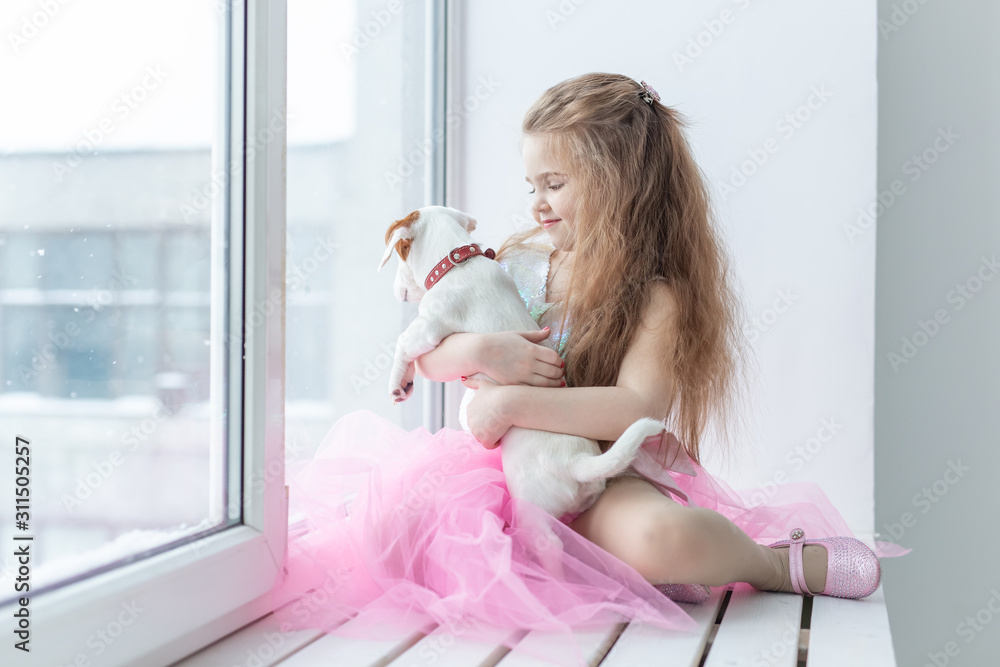 Pet and children concept - Child with dog Jack Russell Terrier at home Pet and children concept - Child with dog Jack Russell Terrier at home