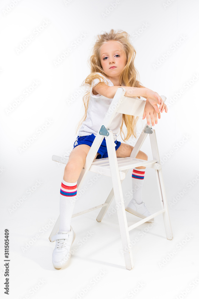 Sports teenager girl in sport suit do exercises isolated on background Sports teenager girl in sport suit do exercises isolated on background