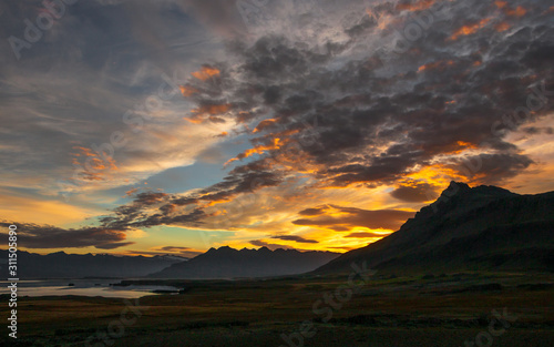 Iceland: Intense colored sunset over steep and rocky mountains
