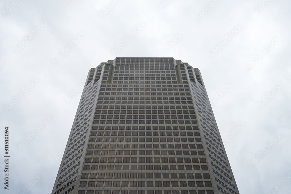 Exterior design and architecture of tall office building decorated with mirror glass frame in front of Saint Louis city garden- Missouri, United States Exterior design and architecture of tall office building decorated with mirror glass frame in front of Saint Louis city garden- Missouri, United States