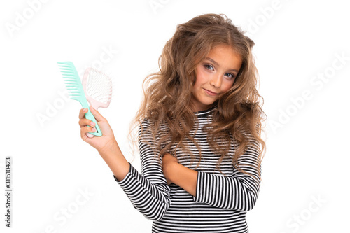 cute girl with a make-up holds combs in hands on a white background