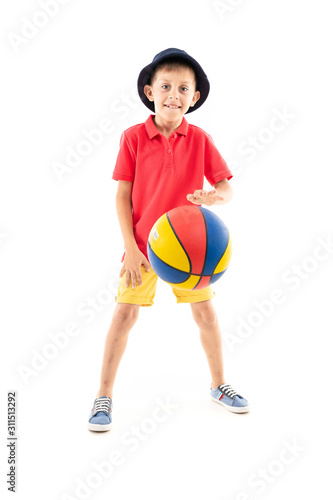 attractive young sporty smiling boy throws a basketball ball on a white background