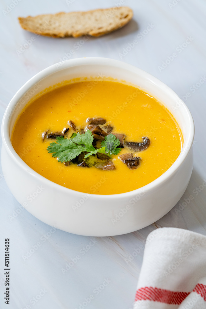 Homemade Thai Sweet Potato Soup with Cilantro, Coconut Milk Cream, Lime and Mushrooms.