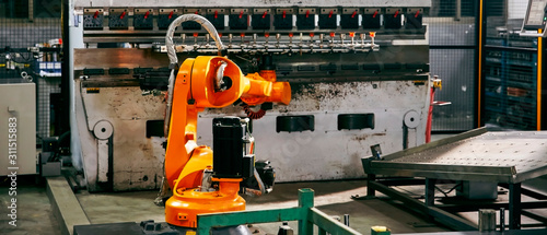 Robotic arm on heavy factory assembly line is moving